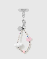 Handmade pastel pink heart and cloud bead phone strap by STICKYZOO with silver-tone engraved hardware, shown with the Phone Strap Card