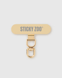 STICKYZOO Phone Strap Card — slim universal connector tab with a gold-tone swivel clasp that clips any phone strap to any phone.