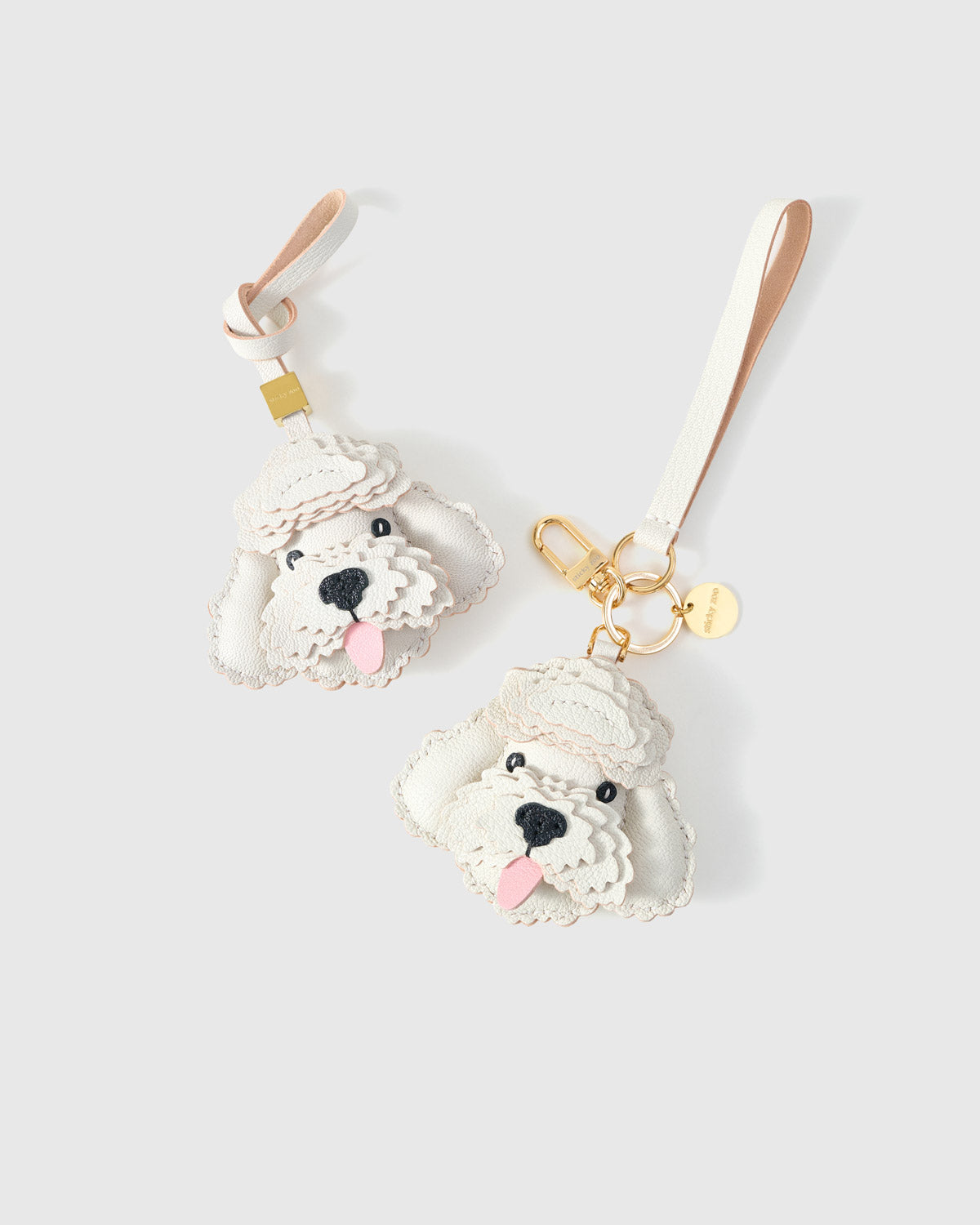 Poodle leather bag charm shown in both attachment options — handmade French Alran goatskin, dual attachment for bags or keys. STICKYZOO Amsterdam design.