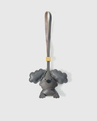 Handmade Poodle leather bag charm — full-grain French Alran goatskin with visible hand-stitched edges. STICKYZOO Amsterdam design.