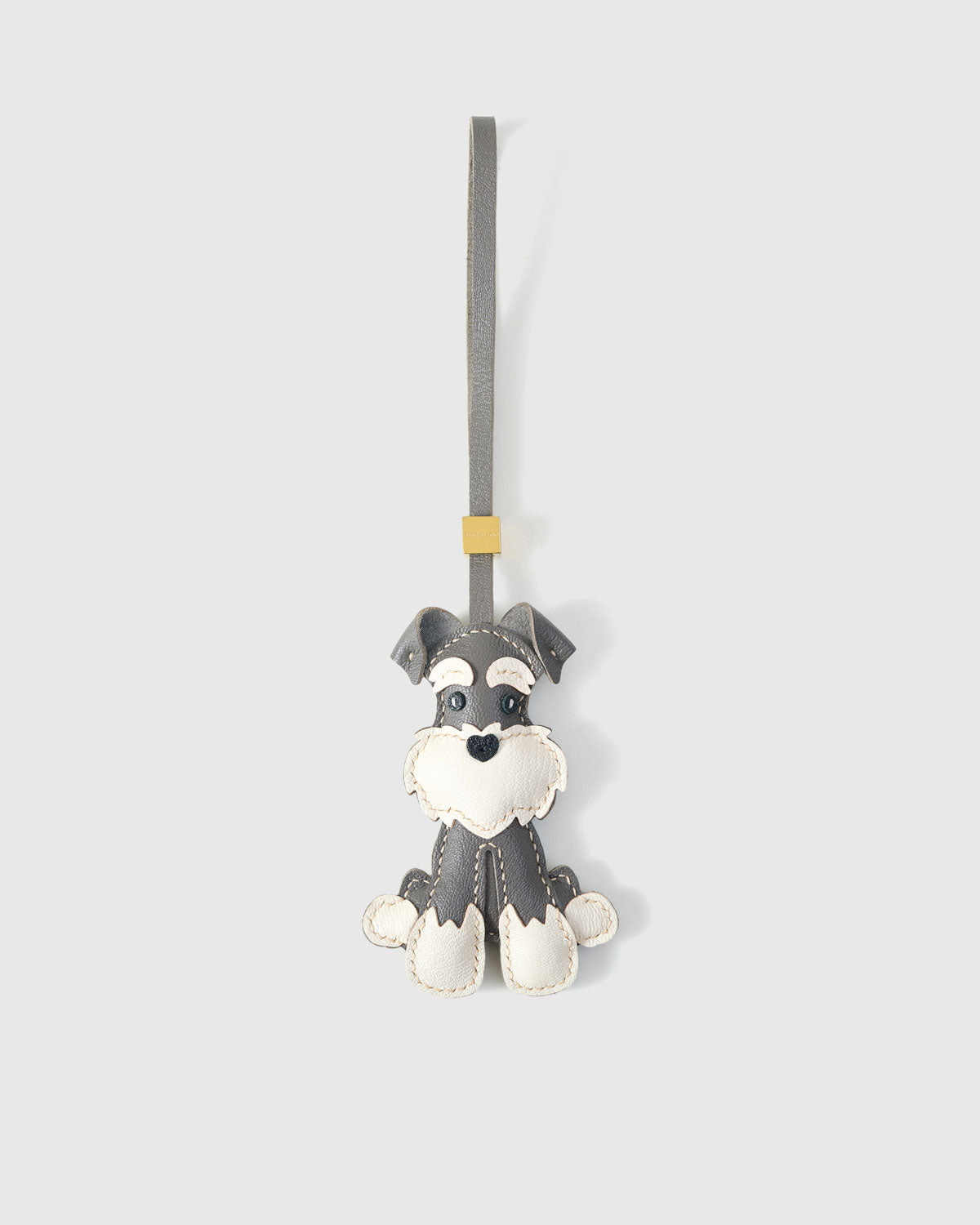 Gray Urban Schnauzer charm handmade from French Alran genuine goatskin and French suede — real full-grain leather from Tarn, since 1903. 3 days of hand-cutting, hand-stitching, hand-layering. Arrives in luxury gift packaging. Designed in Amsterdam.