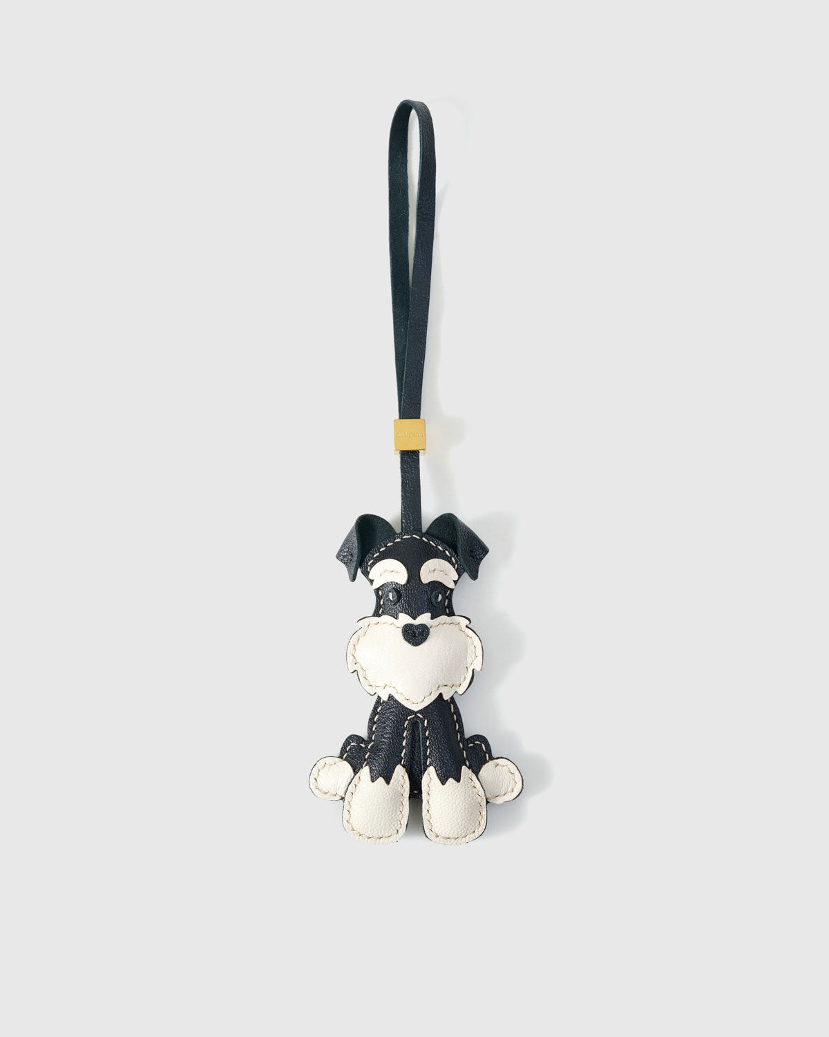 The urban schnauzer charm is made from genuine French Alran goatskin and French suede — real full-grain leather. Never vegan. Never synthetic. The difference shows.