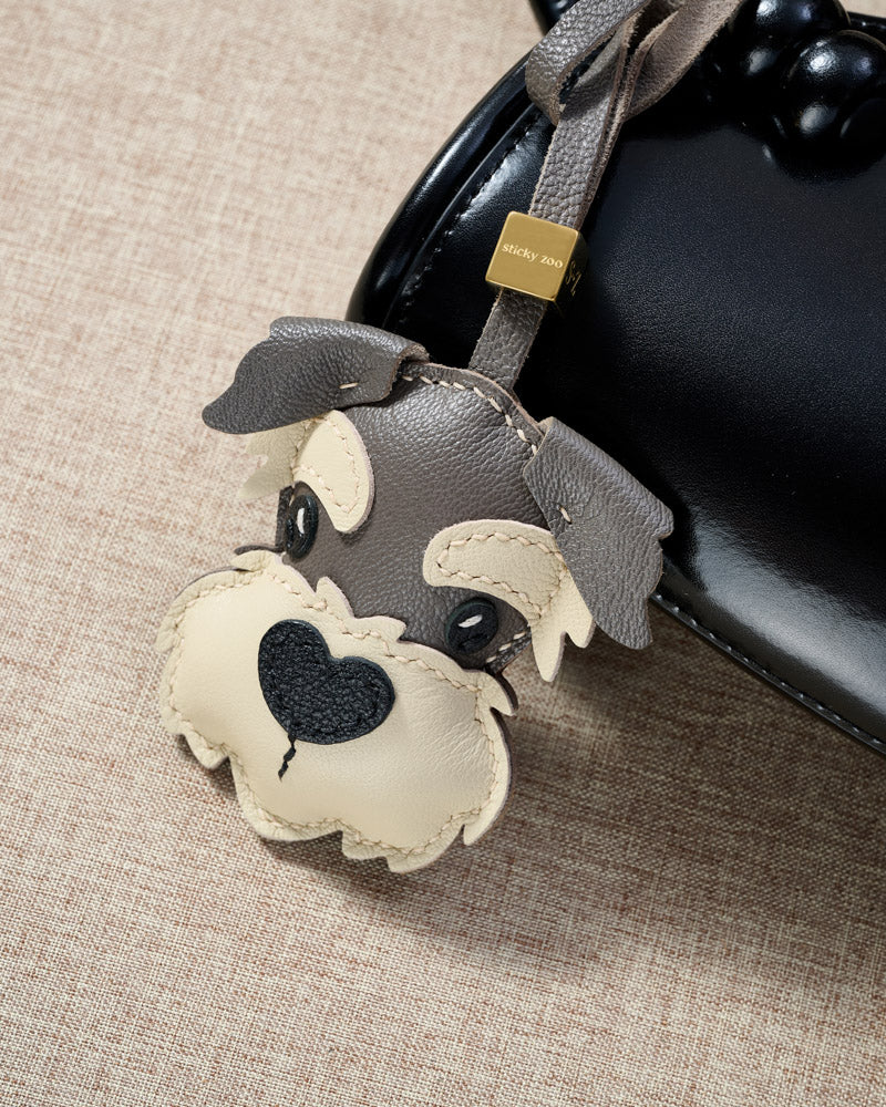 Every panel of the schnauzer charm is cut by hand and stitched through real French leather. Layered slowly for depth — no prints, no stamps.