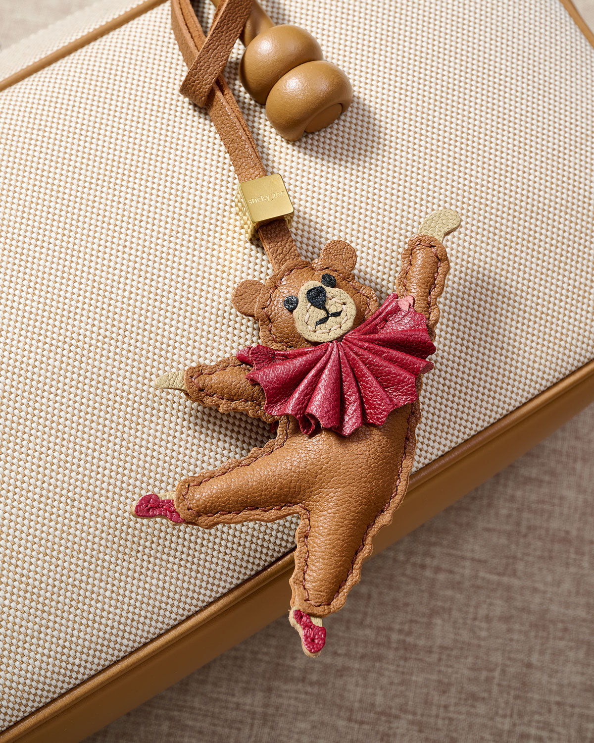 BALLET BEAR CHARM charm styled on a bag — a small, specific piece that turns a simple bag into a personal one.