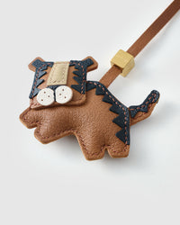 Close-up of the tiger tiko charm — hand-cut and hand-stitched panels of French Alran goatskin. Every layer by hand.