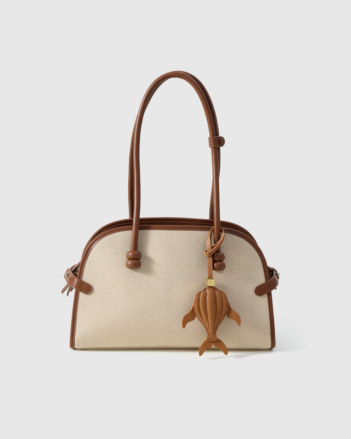Caramel whale charm on a bag, side angle — loved by thousands of ocean lovers. Real French leather, 3 days by hand.