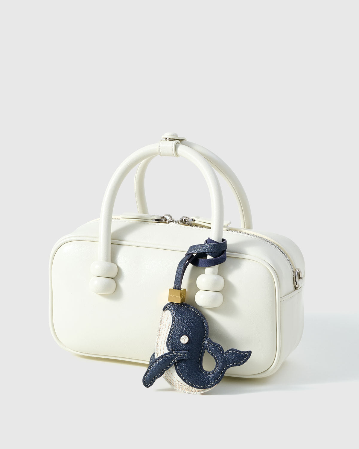 Every panel of the catacea charm is cut by hand and stitched through real French leather. Layered slowly for depth — no prints, no stamps.