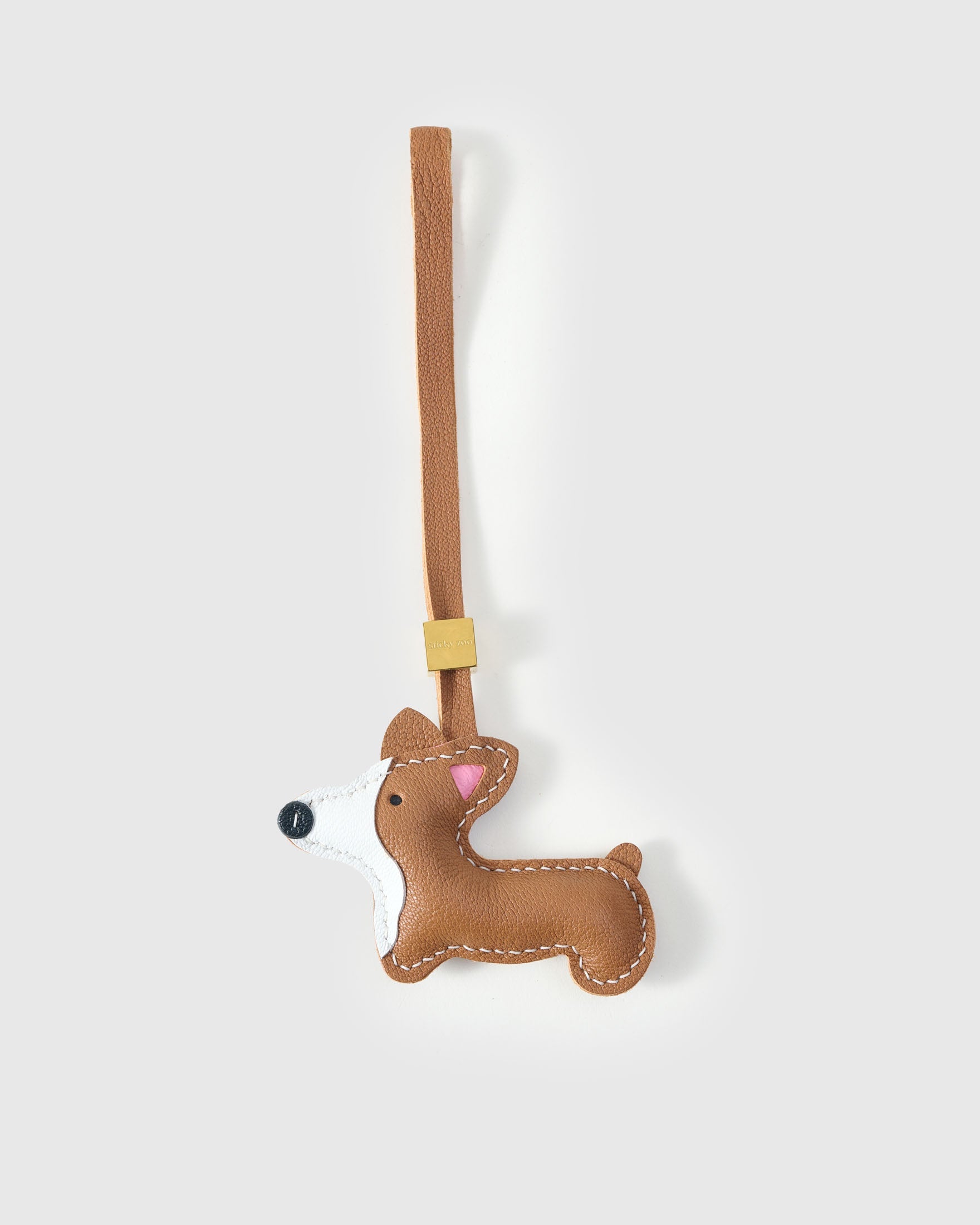 Pembroke Welsh Corgi charm handmade from French Alran genuine goatskin and French suede — real full-grain leather from Tarn, since 1903. 3 days of hand-cutting, hand-stitching, hand-layering. Arrives in luxury gift packaging. Designed in Amsterdam.