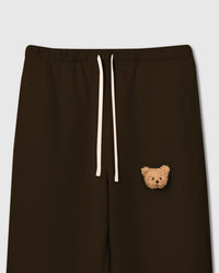Close-up of plush bear face on dark brown cotton showing tonal depth and sherpa texture