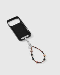 Puppy picnic charm strap attached to a phone case with the included Phone Strap Card