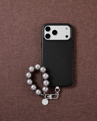 Grey pearl phone strap styled on fabric, loved by thousands of STICKYZOO customers