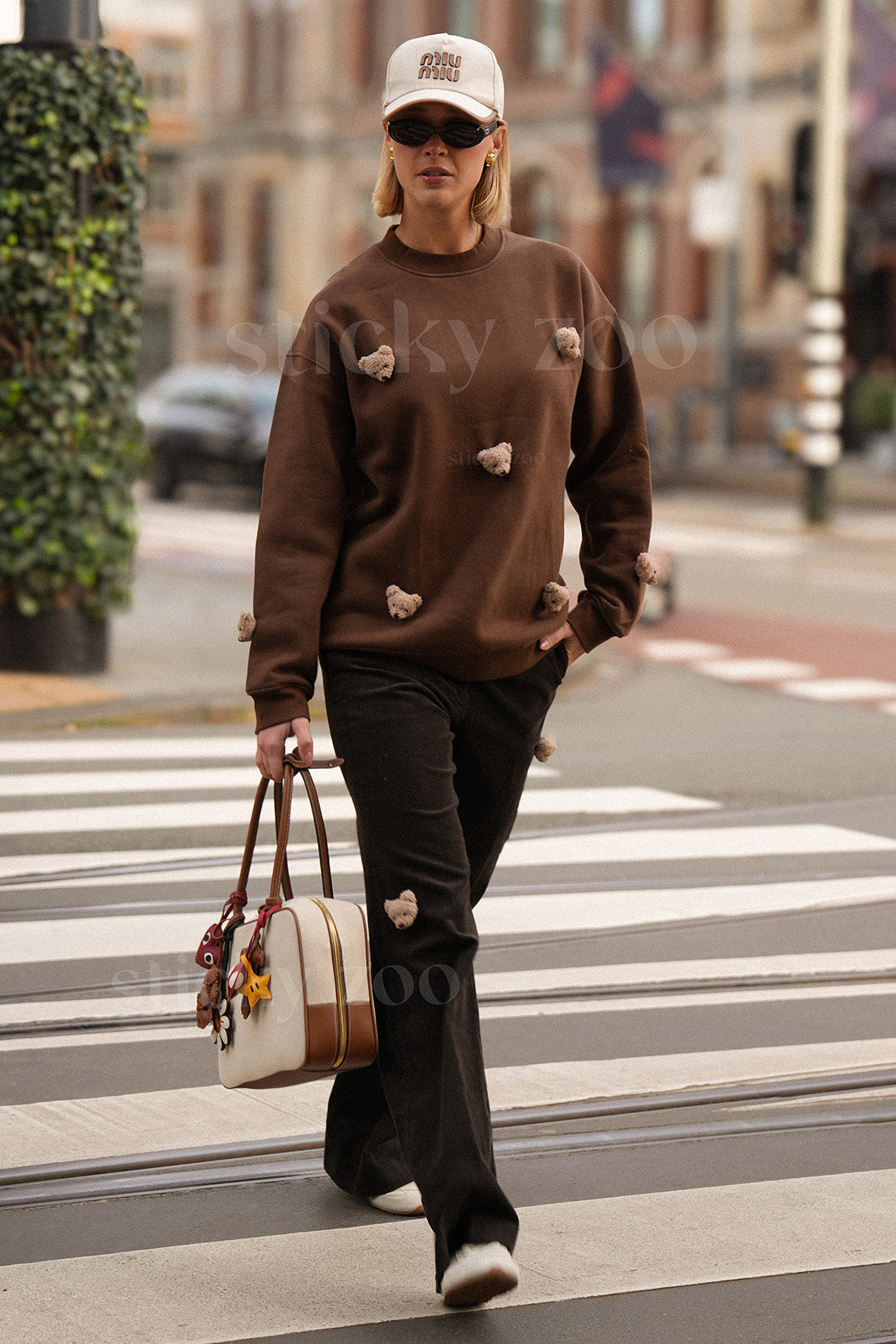 Model wearing STICKYZOO brown Sticky Bear Sweatshirt showing dropped shoulders and relaxed proportions